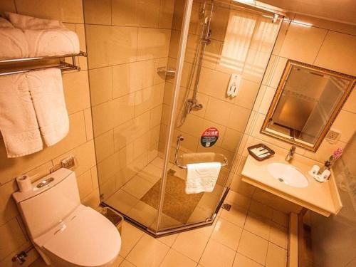 a bathroom with a shower and a toilet and a sink at GreenTree Inn Xi'an Yanta District Dayanta Furongyuan Hotel in Xi'an