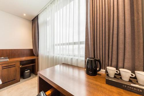 a hotel room with a table and a window at CS Premier Hotel in Seoul