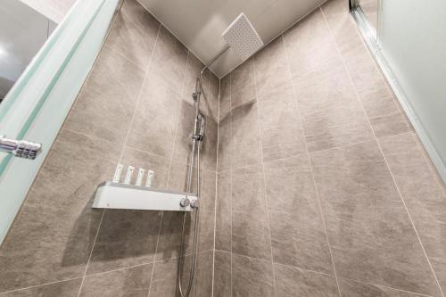 a bathroom with a shower with a sink at CS Premier Hotel in Seoul