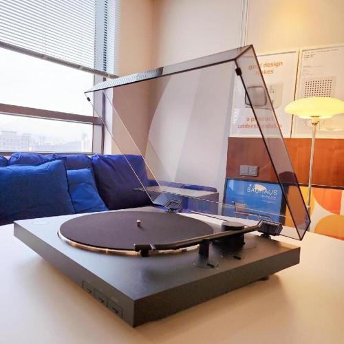 a large laptop on a table in front of a couch at CS Premier Hotel in Seoul