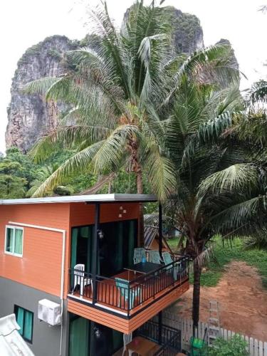 a house with palm trees in front of it at Hat yao Seaview Beach Room in Trang