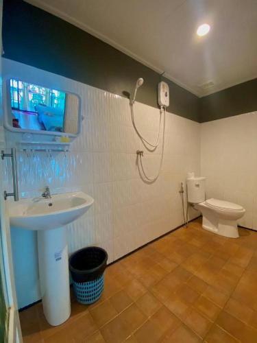 a bathroom with a sink and a toilet at Hat yao Seaview Beach Room in Trang