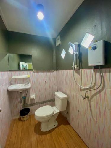 a small bathroom with a toilet and a sink at Hat yao Seaview Beach Room in Trang