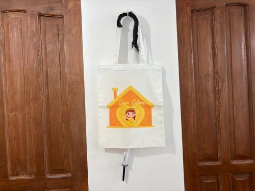 a bag hanging on a wall next to a door at Casa Celine Dumaguete in Dumaguete