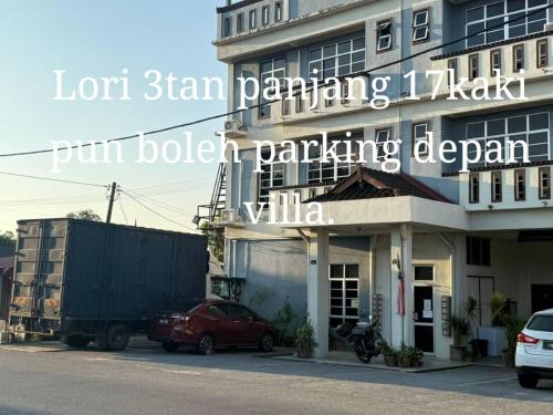 a building with a red car parked in front of it at Villa D'Doa Maju in Kuala Terengganu