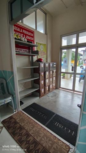 a room with a door open to a room with a shelf at Villa D'Doa Maju in Kuala Terengganu