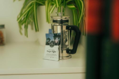 a blender sitting on a counter next to a plant at Kilmarnock House in Dunedin