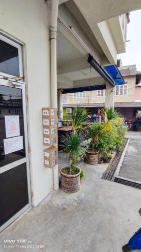 a parking lot with a bunch of plants in a building at Villa D'Doa Maju in Kuala Terengganu