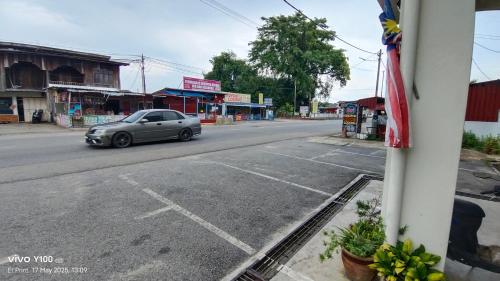 a car driving down a street in a town at Villa D'Doa Maju in Kuala Terengganu
