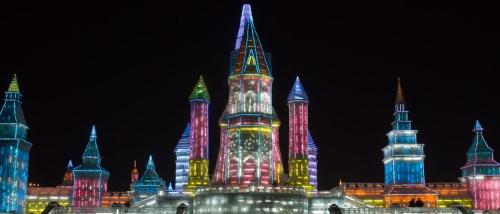 a lit up city at night with colorful lights at 7 Days Inn Harbin West Railway Station in Harbin