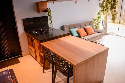 a kitchen with a stove and a couch in a room at Casa com vista para o mar e piscina em Milagres in São Miguel dos Milagres