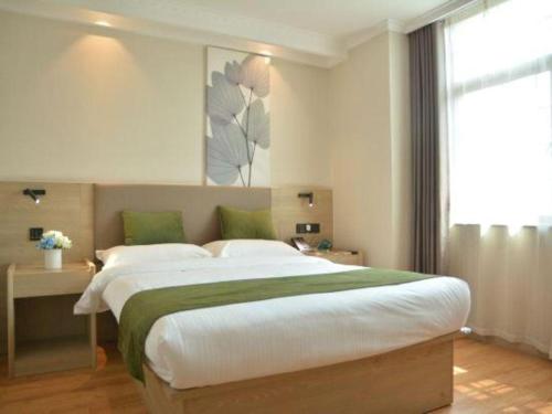 a bedroom with a large bed and a window at GreenTree Inn Xuzhou High Speed Railway Station Express Hotel in Xuzhou