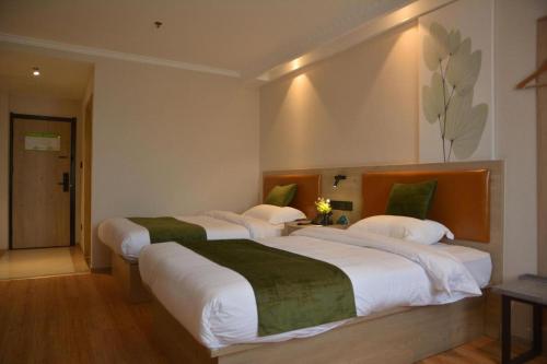 two large beds in a hotel room with at GreenTree Inn Xuzhou High Speed Railway Station Express Hotel in Xuzhou