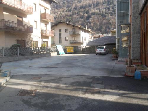 a parking lot with a car parked in front of buildings at Albergo Motel Dosdè B&B in Grosio