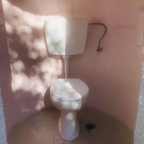 a bathroom with a white toilet in a room at Barreira Beachfront Tents 8 in Kalamata