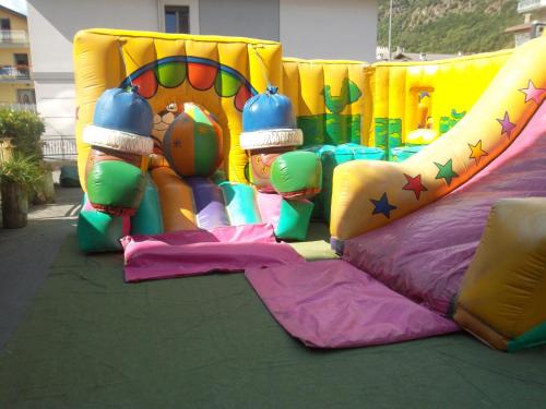 a childs play area with an inflatable bounce house at Albergo Motel Dosdè B&B in Grosio