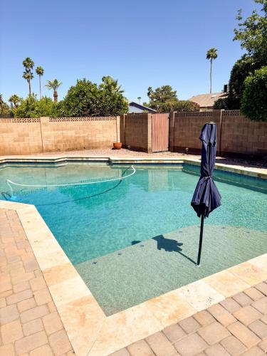an umbrella sitting in the middle of a swimming pool at Hermosa Hideaway in Tempe
