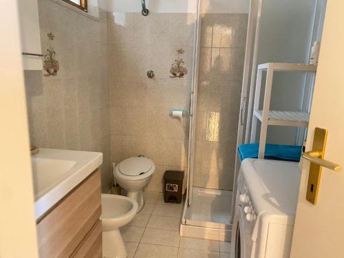 a small bathroom with a toilet and a shower at Marcelli trilocale 200 mt mare giardino posto auto in Marcelli