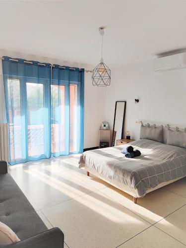 a bedroom with a large bed and a couch at Maison provençale les fourmis in Les Issambres