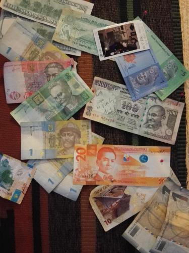 a pile of foreign money on a table at Lea Guest House in Tbilisi City