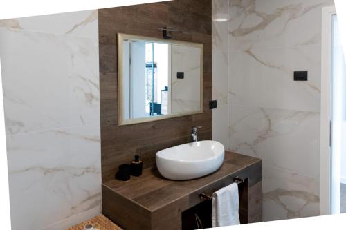 a bathroom with a sink and a mirror at Villa Andolini in Momjan