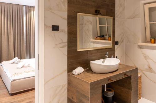 a bathroom with a sink and a mirror at Villa Andolini in Momjan