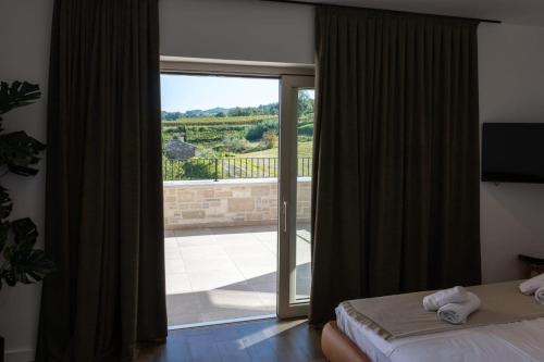 a bedroom with a sliding glass door with a view at Villa Andolini in Momjan