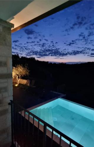 a view of a swimming pool at night at Villa Andolini in Momjan