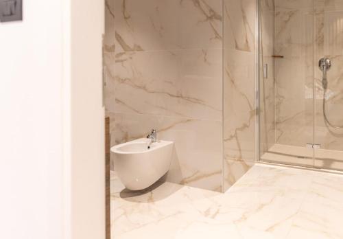 a bathroom with a shower and a toilet and a sink at Villa Andolini in Momjan