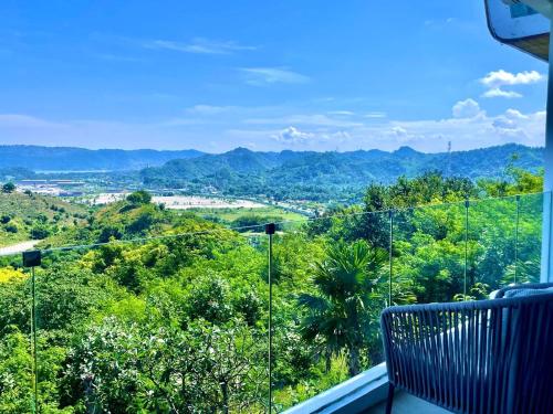 a balcony with a view of trees and mountains at Truntum Boutique Mandalika in Kuta Lombok