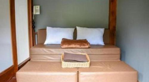 a bed with a purse sitting on top of it at VillaTel Salse in Bandung