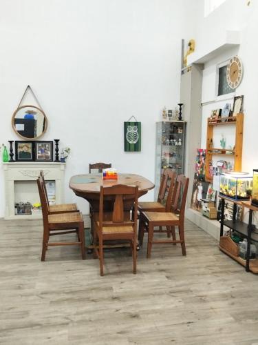 a dining room table and chairs in a store at Homestay Lilo Lila in Purwosari