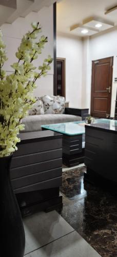 a living room with a vase with a plant in it at Banarasi Courtyard in Varanasi