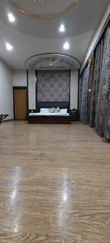 a large room with a bed and a wooden floor at Banarasi Courtyard in Varanasi
