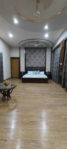 a large room with a bed and a table at Banarasi Courtyard in Varanasi