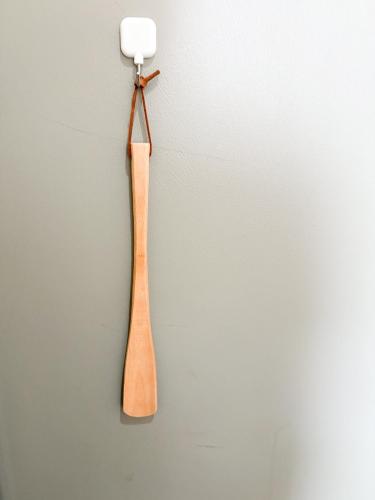 a wooden spoon hanging on a wall at Yamato Saidaiji Hotel SINDAI in Nara