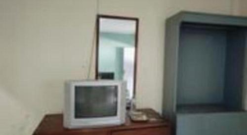a television sitting on a dresser in a room at Alexander Hotel Tegal in Tegal