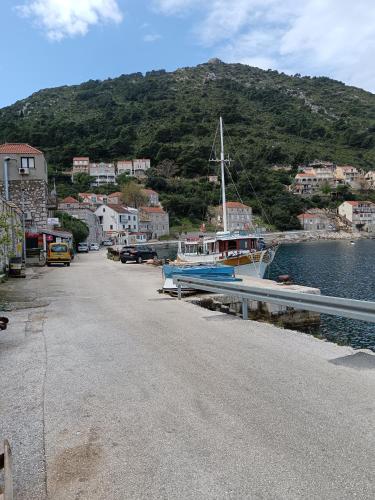 a boat is docked at a dock next to the water at Studio apartment Dragana in Sobra