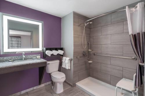 a purple bathroom with a toilet and a shower at La Quinta by Wyndham Glenwood Springs in Glenwood Springs