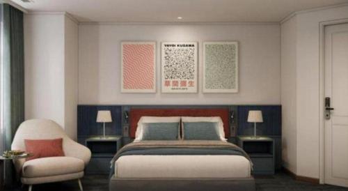 a bedroom with a large bed and a chair at Lenid Hotel Tho Nhuom in Hanoi