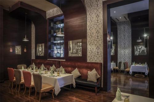 a dining room with a table and chairs at Kempinski Al Othman Hotel Al Khobar in Al Khobar
