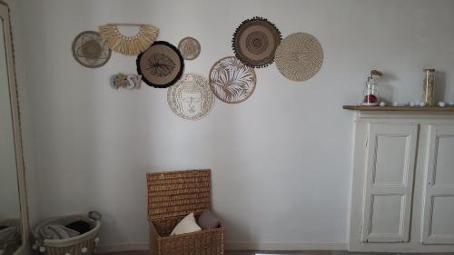 a wall with a bunch of plates on a wall at Gîte La Giroflee in Meillonnas