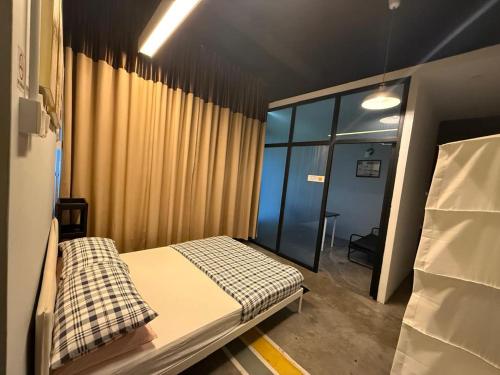 a small room with a bed and a window at HuttonSTAY at Georgetown in George Town
