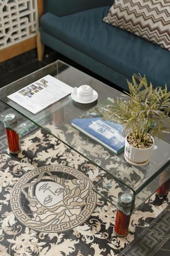 a glass coffee table in a living room at Bella Rosa Trendy Hotel & Spa in Hanoi
