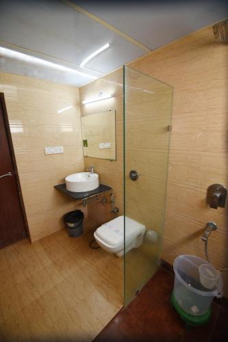 a bathroom with a toilet and a sink at The Byke Old Anchor Beach Resort & Spa in Cavelossim