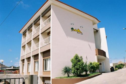 a large white building with a dinosaur painted on it at Areia Dourada in Porto Santo