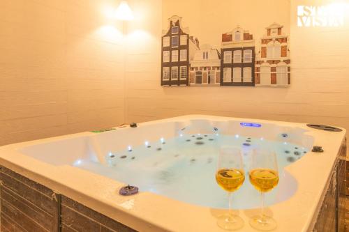 two glasses of wine in a jacuzzi tub at StayVista at Viva La Vida - Bonfire, Jacuzzi, AC in Bhīm Tāl
