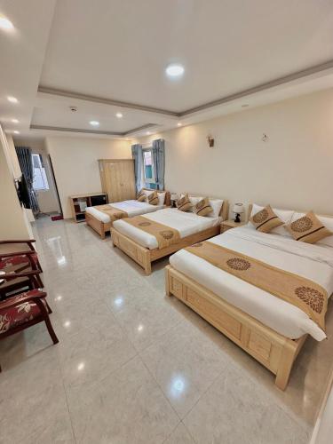 a room with three beds in a room at 1 House in Da Lat