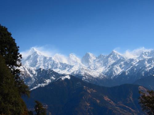 a view of a snow covered mountain range at Geeta Homestay in Munsyari
