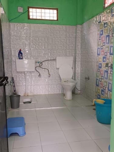 a bathroom with a toilet and a sink at Geeta Homestay in Munsyari